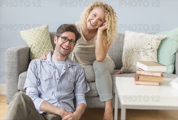 Portrait of couple in living room.