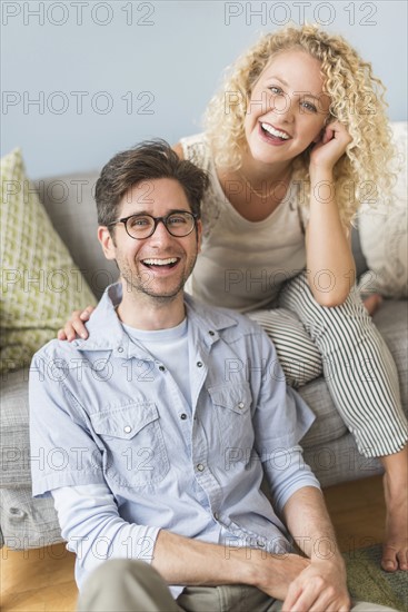 Portrait of couple in living room.