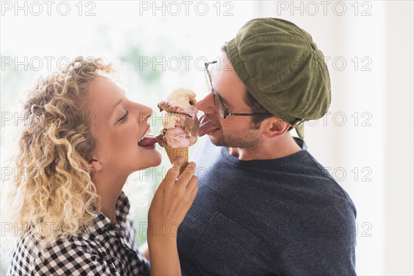 Couple eating ice cream together.