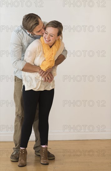 Young couple embracing and kissing.