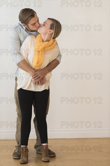 Young couple embracing and kissing.