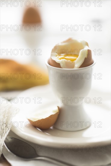 Close up of soft boiled egg in egg cup.