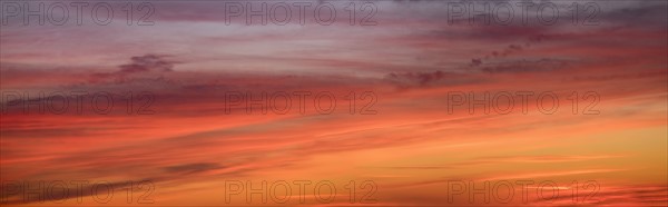 Panoramic view of sunrise sky with clouds.