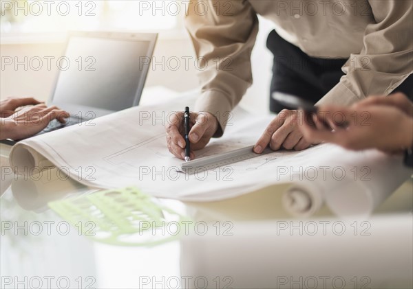 Close up of hands of men and woman working wt desk.