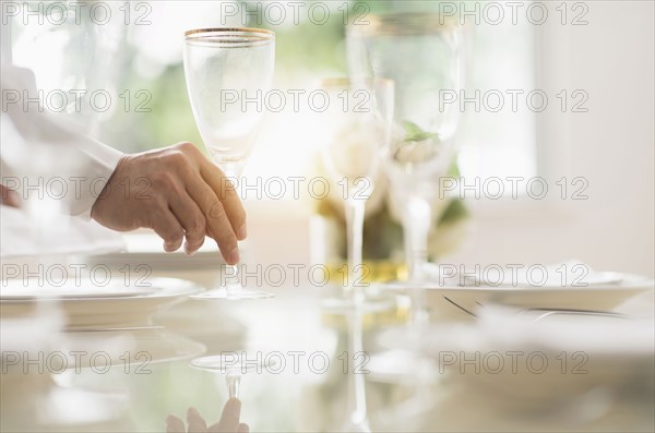 Close up of man's hand setting place in restaurant.