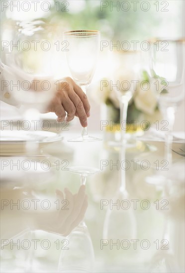 Close up of man's hand setting place in restaurant.