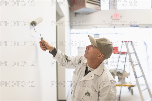 Manual worker painting wall.