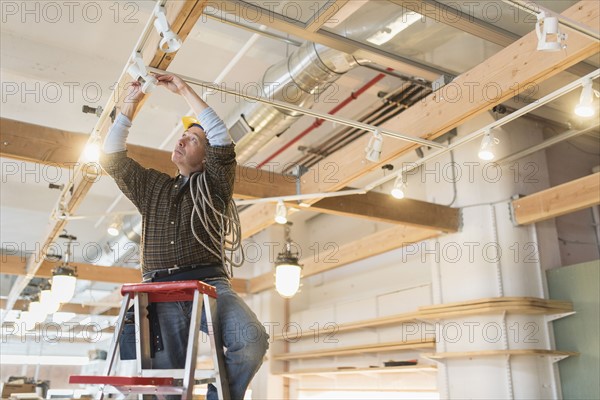 Electrician fixing lightning equipment.