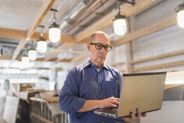 Business owner working with laptop.