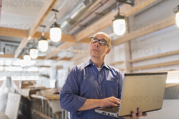 Business owner working with laptop.