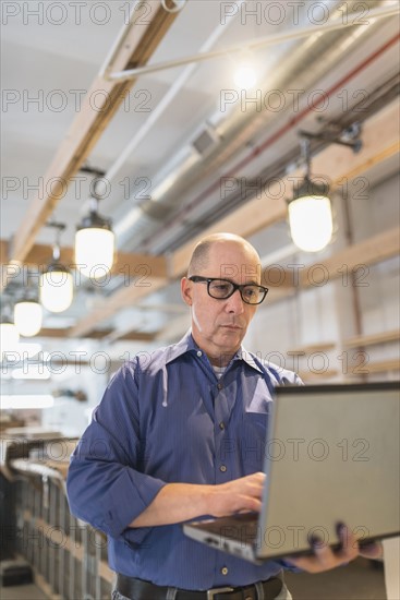 Business owner working with laptop.