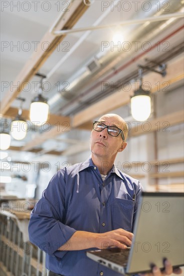 Business owner working with laptop.