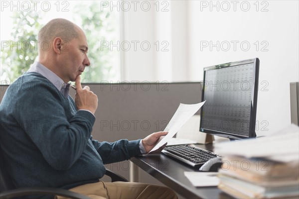 Mature businessman working in office.