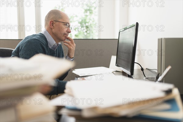Mature businessman working in office.