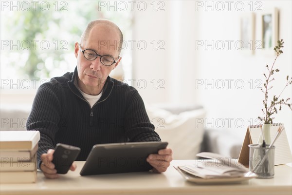 Mature man working in home office .