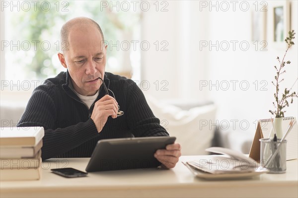 Mature man working in home office .