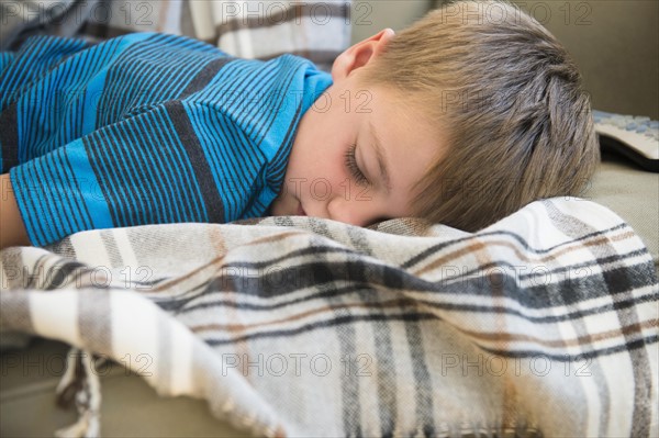 Boy (6-7) sleeping on sofa