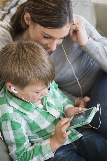 Mother and son (6-7) listening to music