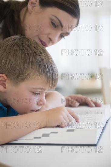 Female teacher and schoolboy (6-7) in classroom