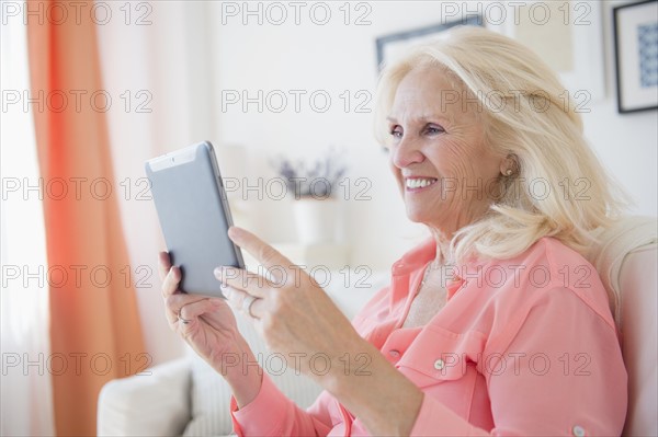 Portrait of senior woman using digital tablet