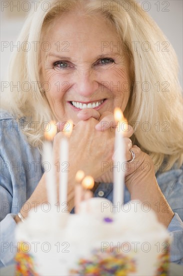 Portrait of senior woman with birthday cake