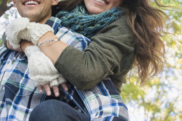 Man giving his girlfriend piggyback ride