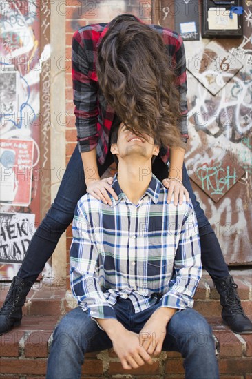 Young couple face to face on sidewalk