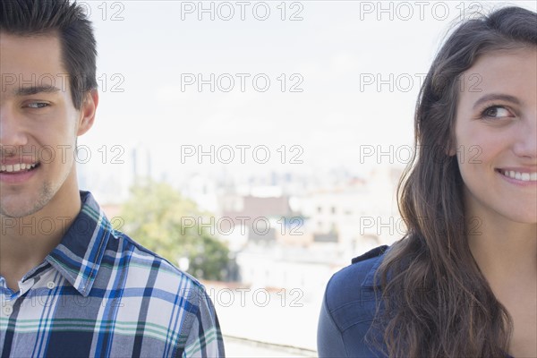 Young couple looking sideways