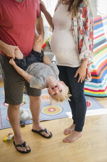 Father playing with son (2-3) in living room