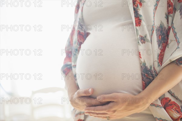 Mid-section of pregnant woman