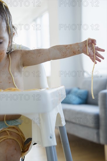 Girl (2-3) eating spaghetti