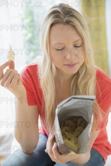 Woman eating crisps