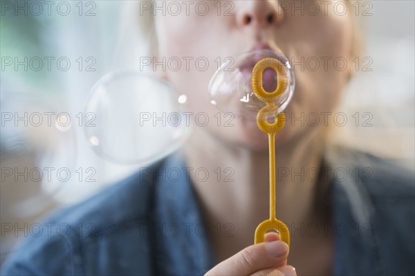 Woman blowing bubbles