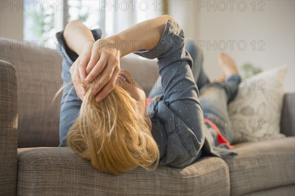 Woman lying on sofa