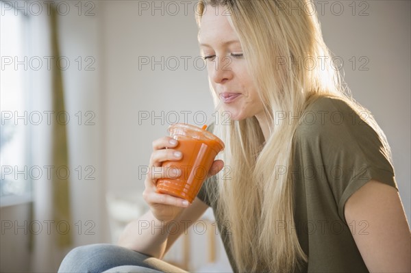 Woman drinking carrot juice