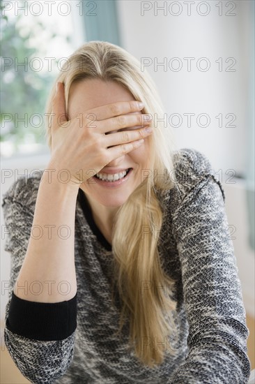 Woman covering her face