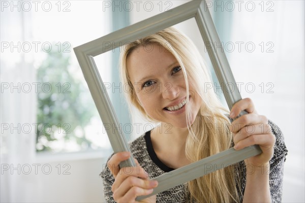 Woman holding picture frame