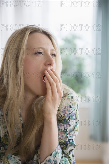 Portrait of woman yawning