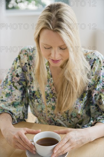 Woman sitting with cup of coffee