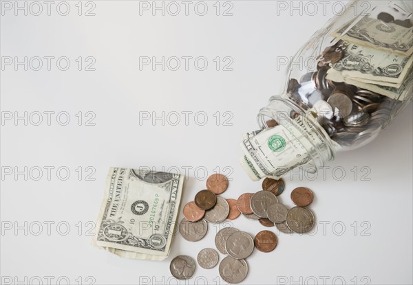 Studio Shot of banknotes and coins in jar