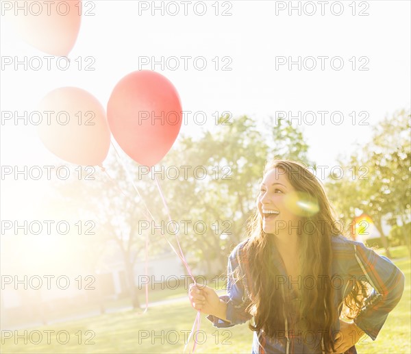 Woman with balloons outdoors