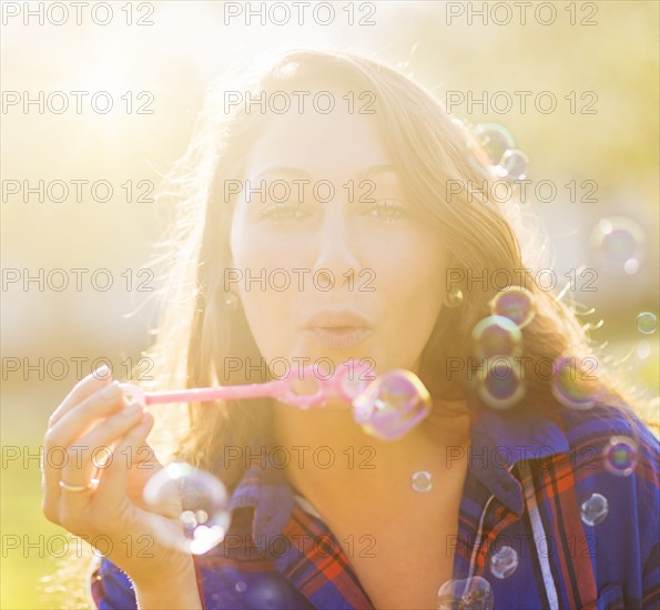 Woman blowing bubbles