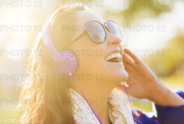 Woman in sunglasses and headphones outdoors