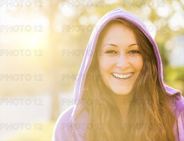 Portrait of smiling woman in hoodie