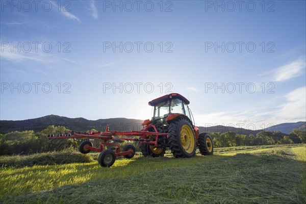 Tractor in field at sunset