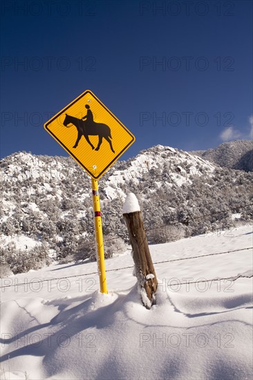 View of road sign and mountain in winter