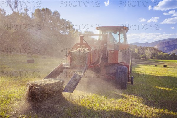 Tractor in field at sunset