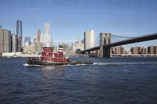 View of boat, Brooklyn bridge and cityscape