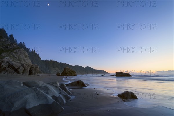 Scenic view of coastline at sunset