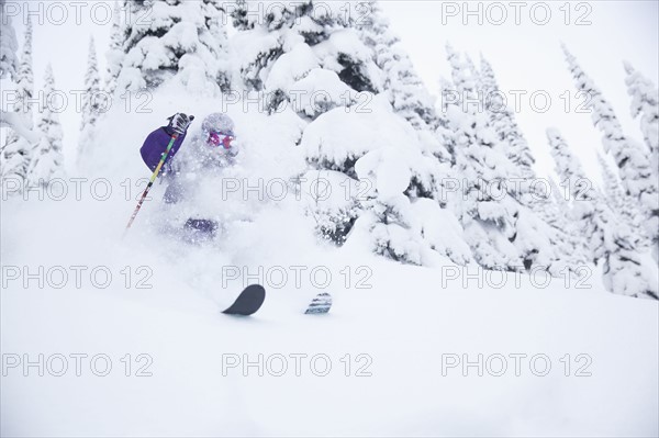 Young man skiing in forest